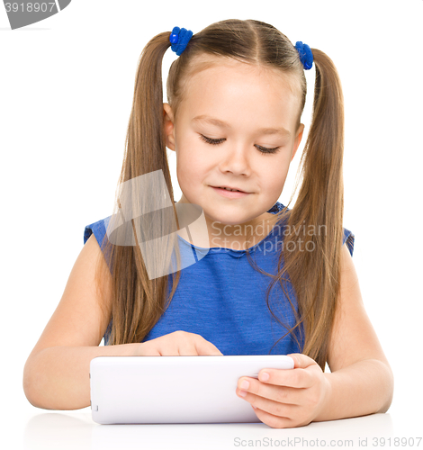 Image of Young cheerful girl is using tablet