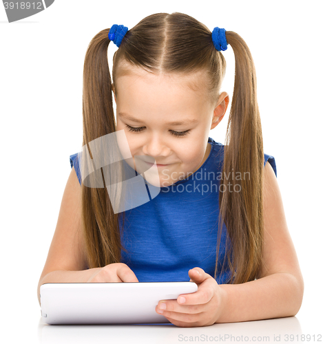 Image of Young girl is using tablet