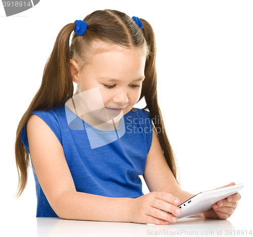 Image of Young girl is using tablet