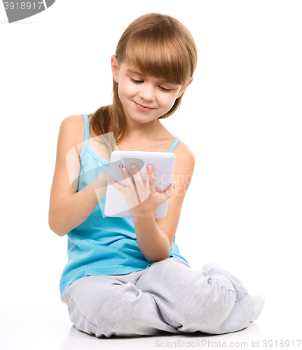 Image of Young girl is using tablet