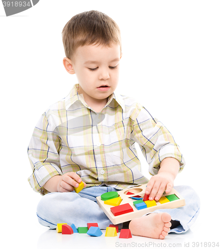 Image of Little boy is playing with toys