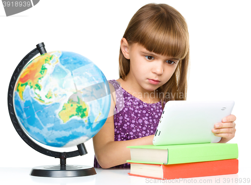 Image of Young girl is using tablet