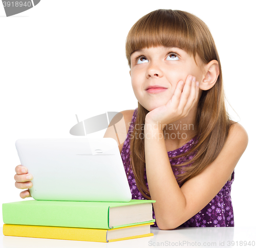 Image of Young girl is using tablet