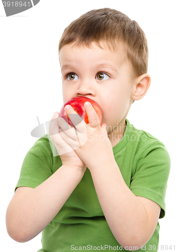 Image of Portrait of a cute little boy with red apple