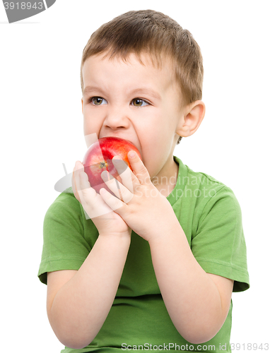 Image of Portrait of a cute little boy with red apple