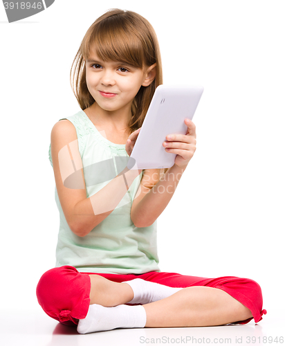 Image of Young girl is using tablet