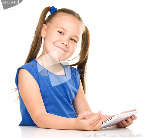 Image of Young cheerful girl is using tablet