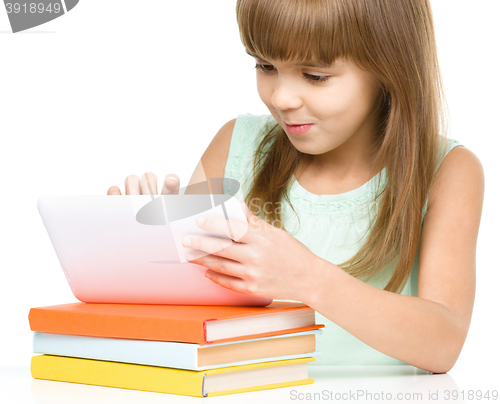 Image of Young girl is using tablet