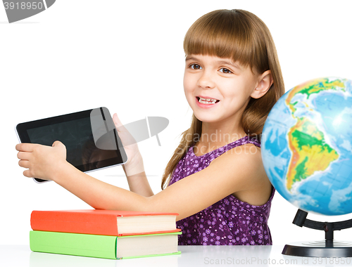 Image of Young girl is showing tablet
