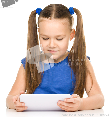 Image of Young girl is using tablet