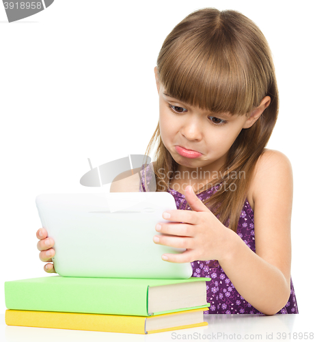 Image of Young girl is using tablet