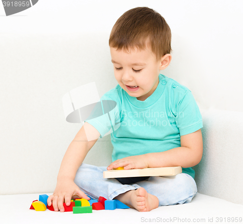 Image of Boy is playing with puzzle