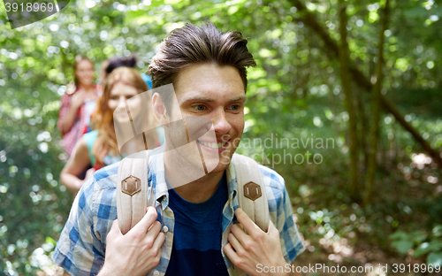 Image of group of smiling friends with backpacks hiking