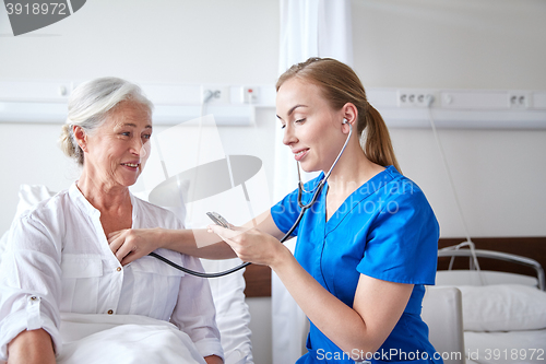 Image of nurse with stethoscope and senior woman at clinic