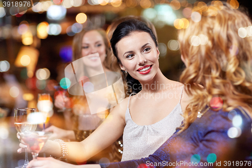 Image of happy women with drinks at night club