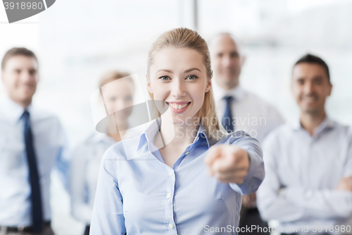 Image of smiling businesswoman pointing finger on you