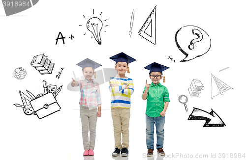 Image of happy children in bachelor hats and eyeglasses