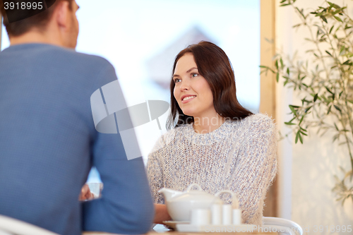 Image of happy couple drinking tea at cafe or restaurant