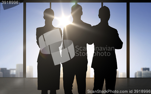Image of business people silhouettes over office background