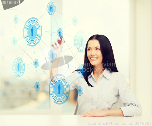 Image of smiling woman writing on virtual screen