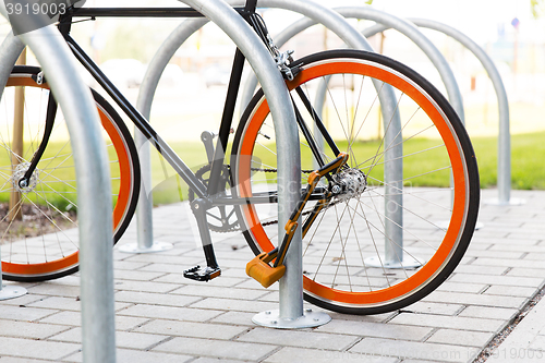 Image of close up of bicycle locked at street parking