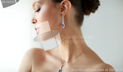 Image of beautiful asian woman with earring and pendant