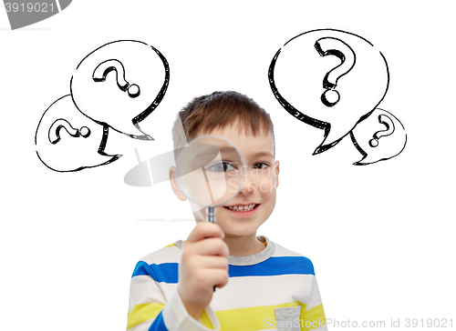 Image of happy little boy looking through magnifying glass