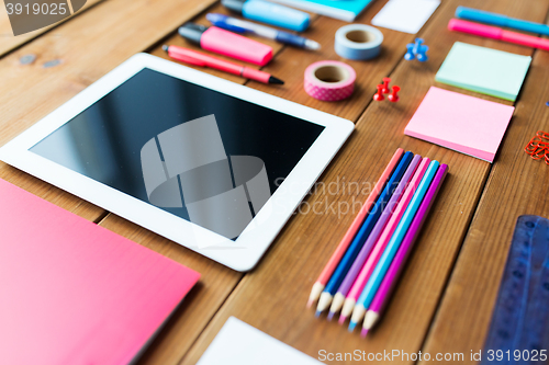 Image of close up of school supplies and tablet pc