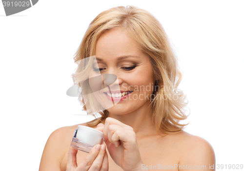 Image of happy woman with cream jar