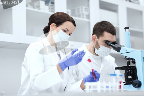 Image of young scientists making test or research in lab