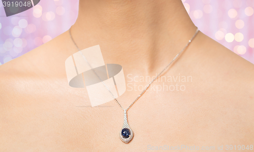 Image of close up of beautiful woman neck with pendant