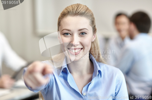 Image of smiling businesswoman pointing finger on you