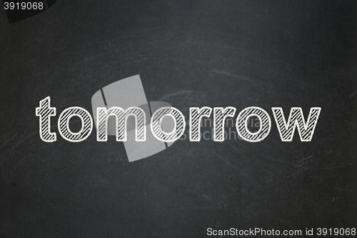 Image of Time concept: Tomorrow on chalkboard background