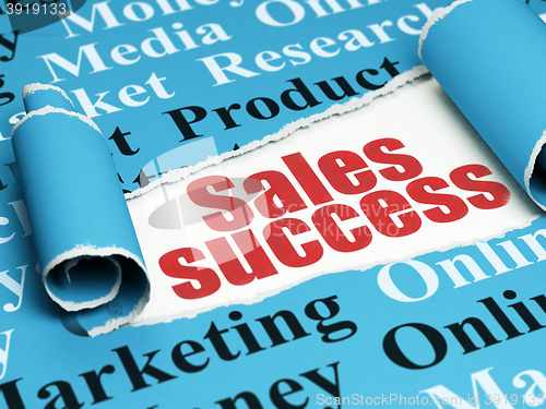 Image of Marketing concept: red text Sales Success under the piece of  torn paper