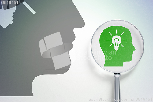 Image of Studying concept:  Head With Light Bulb with optical glass on digital background