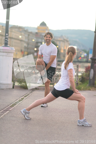 Image of couple warming up before jogging