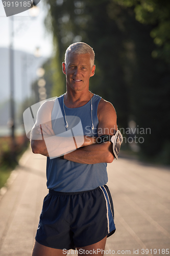 Image of portrait of handsome senior jogging man