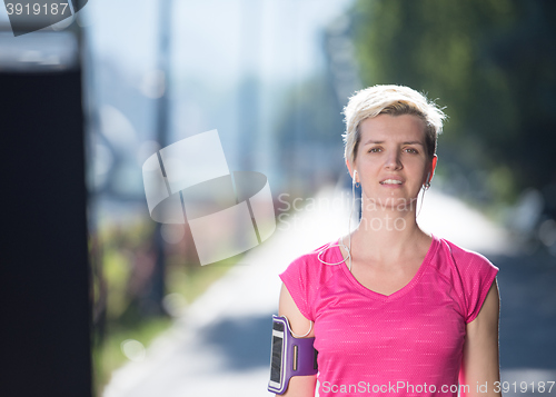 Image of jogging woman setting phone before jogging