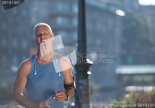 Image of portrait of handsome senior jogging man