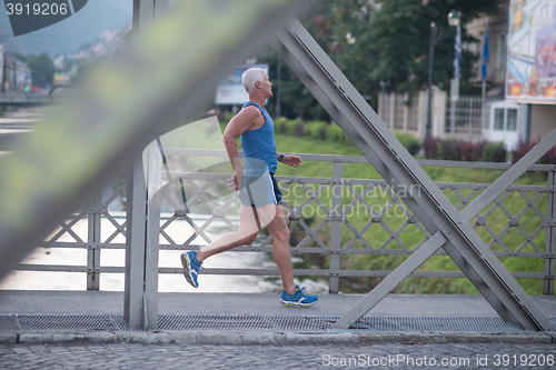 Image of handsome senior man  jogging