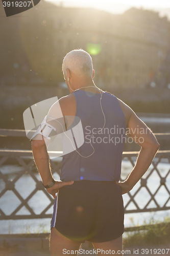 Image of portrait of handsome senior jogging man