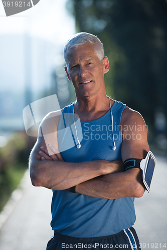 Image of portrait of handsome senior jogging man