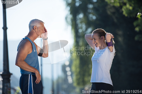 Image of jogging couple planning running route  and setting music