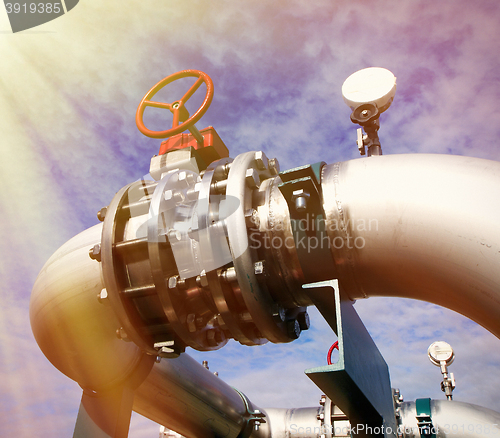 Image of Industrial zone, Steel pipelines and valves against blue sky