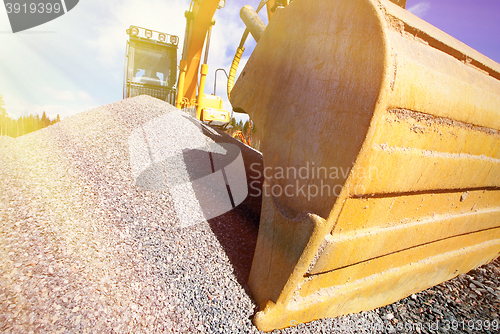 Image of excavator against blue sky    