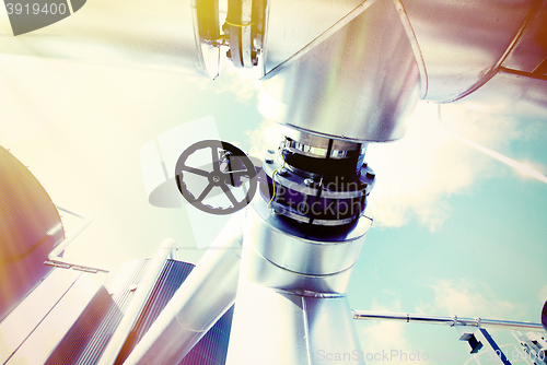 Image of Industrial zone, Steel pipelines and valves against blue sky