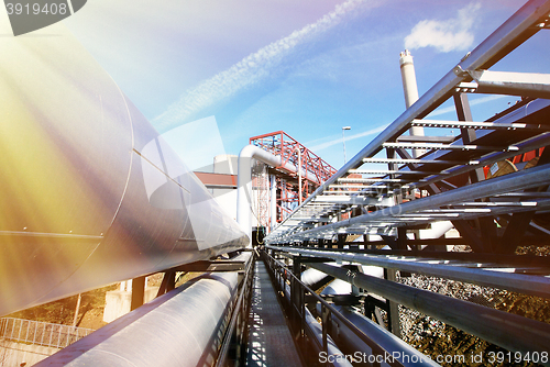 Image of Industrial zone, Steel pipelines and valves against blue sky