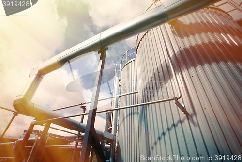 Image of Industrial zone, Steel pipelines and valves against blue sky