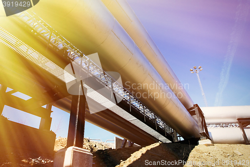 Image of Industrial zone, Steel pipelines and valves against blue sky