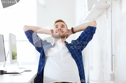 Image of happy creative man with computer at office